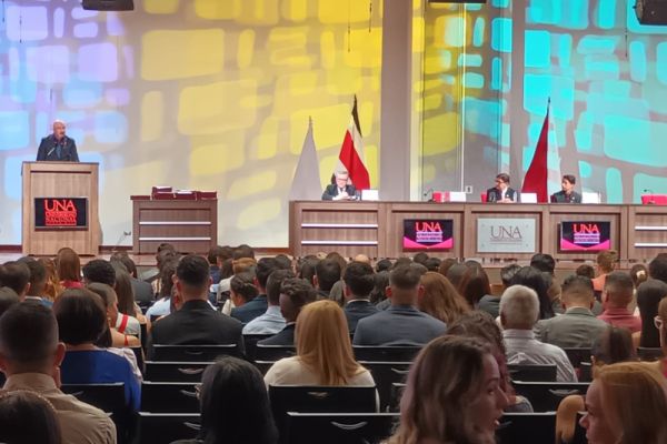 Se muestra al señor Vicerrector de Docencia emitiendo un discurso, frente al público. Fotografía con acercamiento.